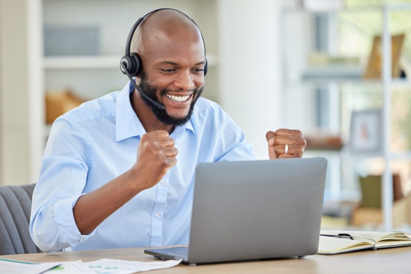 Success, winner or black call center man with laptop in customer service, contact us or CRM consult.